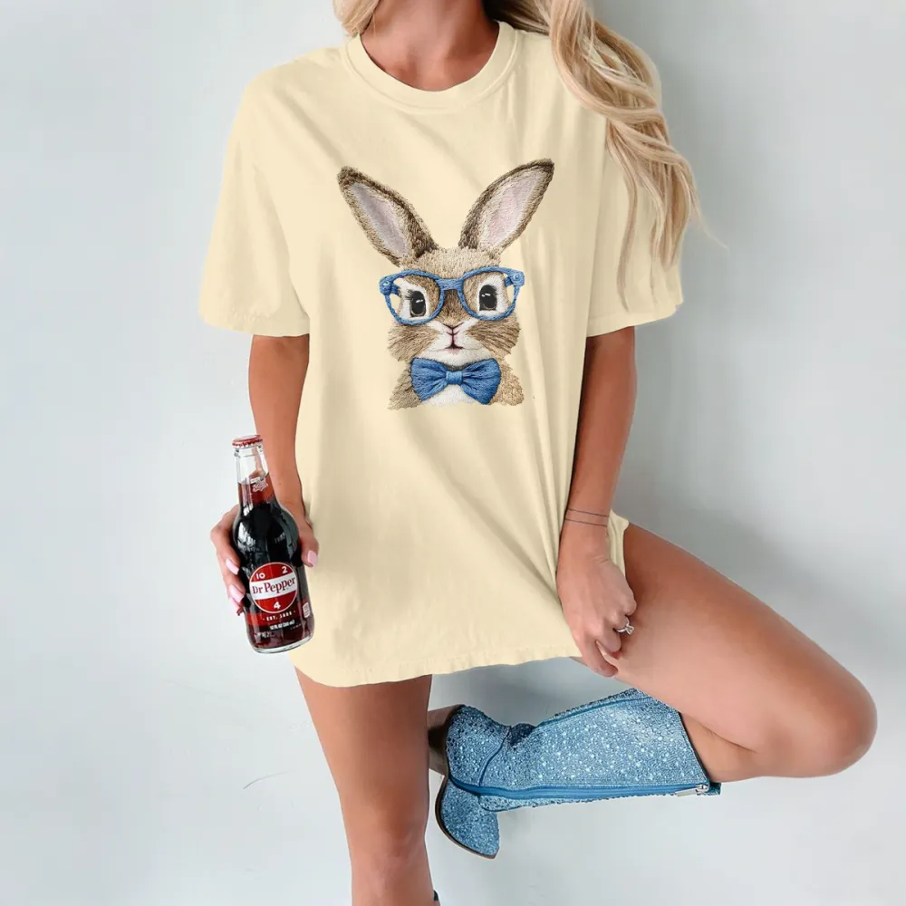 A Rabbit Pattern Wearing Blue Glasses And A Blue Bow Tie Looks Cute And Stylish On A Casual T-Shirt.