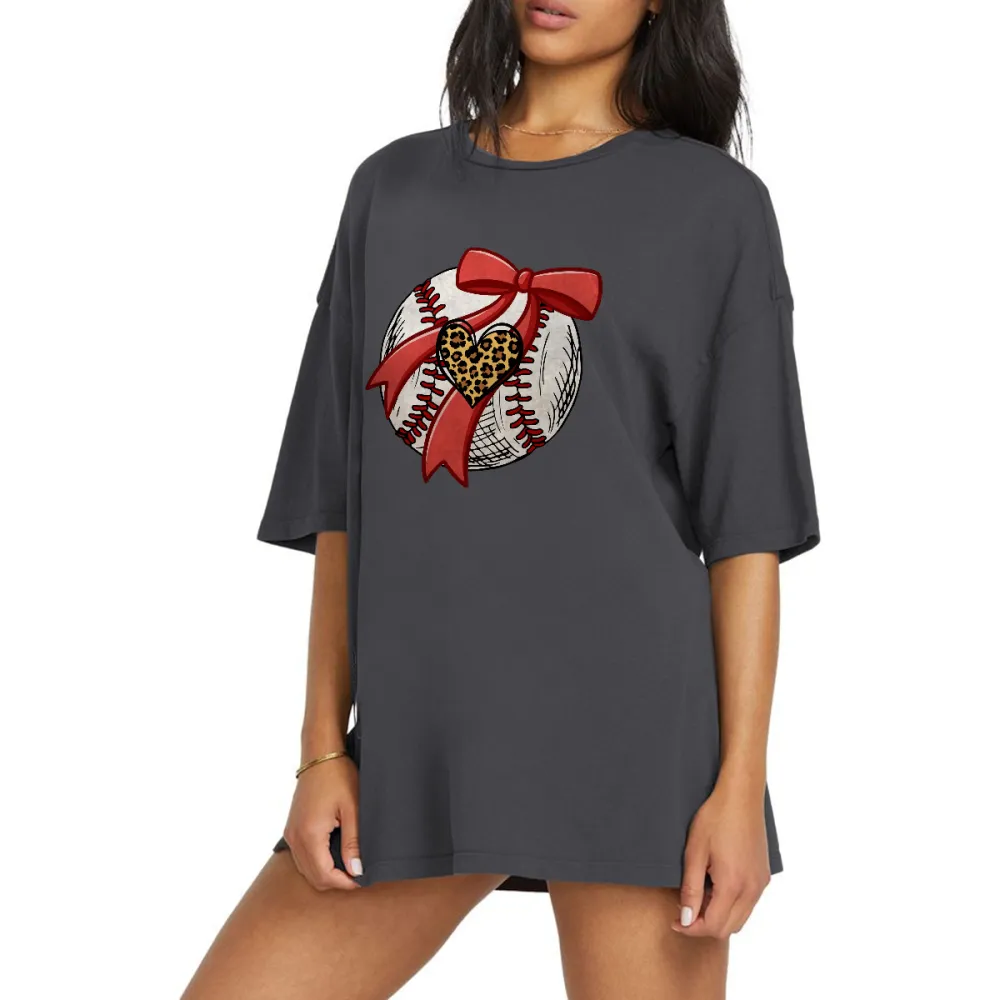 A Pattern Combining A Stitched Baseball, A Red Bow And A Leopard Print Heart. There Is Also A Leopard Print Heart Pattern On The Ball, A Casual T-Shirt.