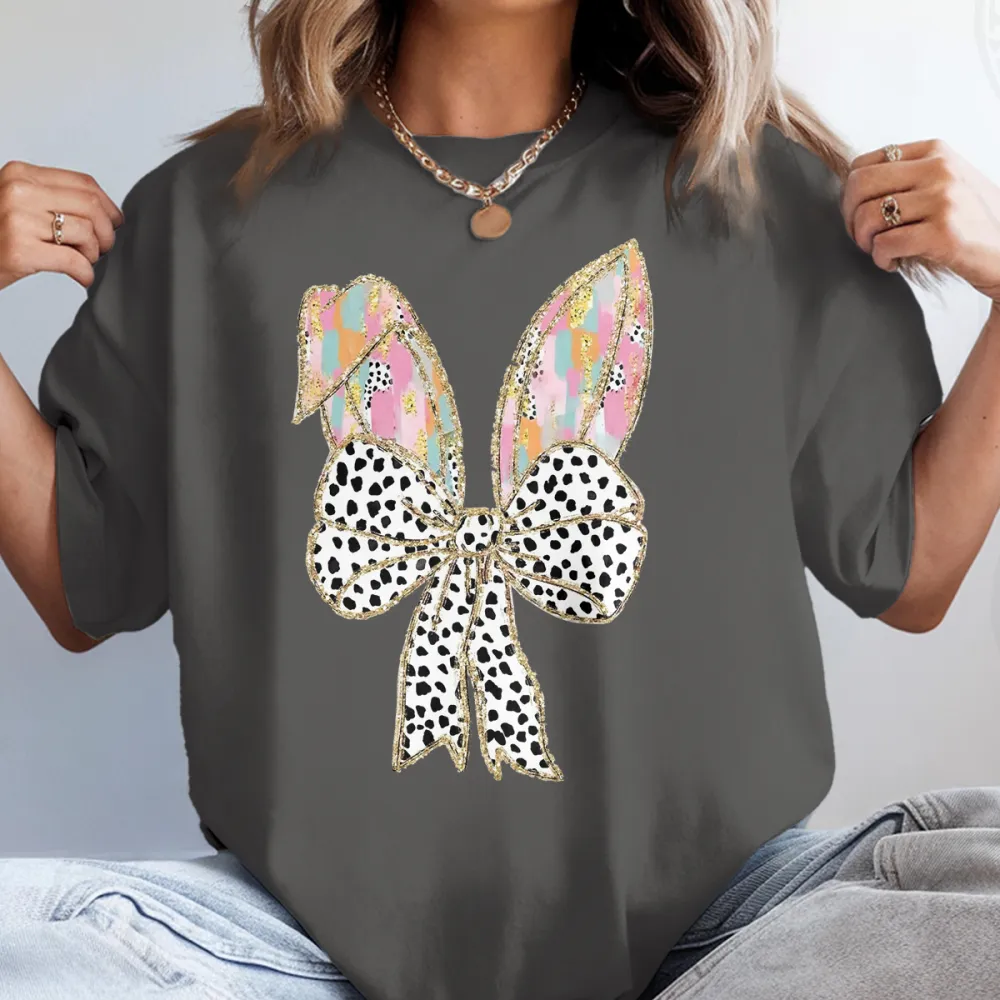 There Are Colorful Geometric Patterns On The Cartoon Rabbit Ears, With Gold Decorations On The Edges And A Big Bow With Black And White Spots, Which Is Lively And Cute, And A Casual T-Shirt.