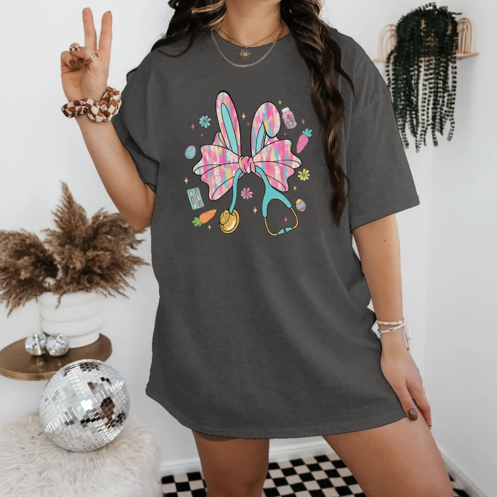 A Big Colorful Bow, Rabbit Ears, And Surrounded By Carrots, Easter Eggs, And Stethoscope Patterns. The Overall Style Is Lively And Casual T-Shirt.