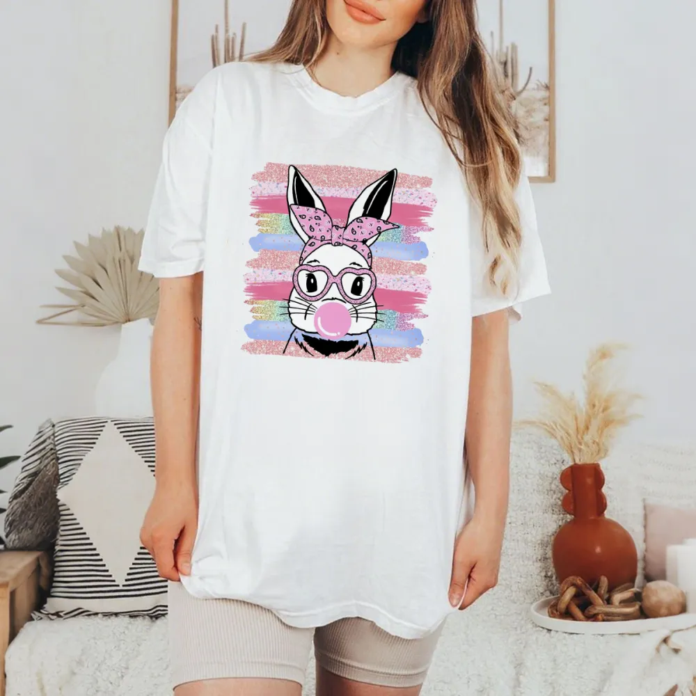The Pattern Of A Rabbit Wearing A Pink Bow And Glasses, Blowing Pink Bubble Gum In His Mouth, With Colorful Striped Brushstrokes In The Background, Playful And Lively Style, Casual T-Shirt.