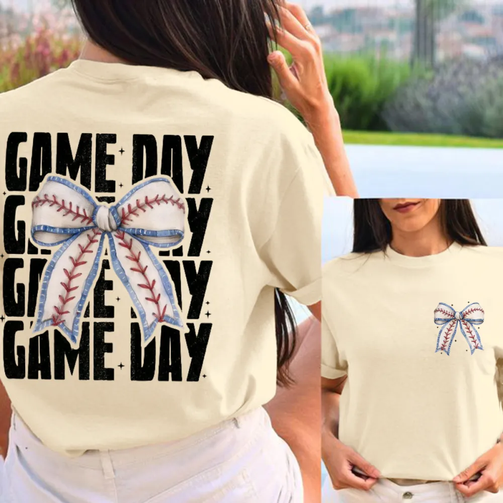 A Casual T-Shirt With Repeated Letters “GAME DAY” And A Bow Pattern In The Middle Designed In The Style Of Baseball Stitching.