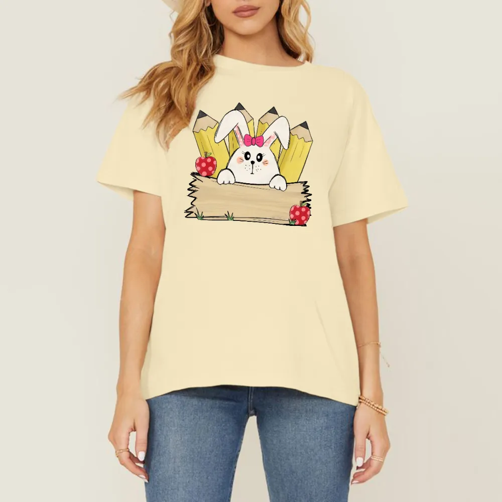 A Cartoon White Rabbit Wearing A Pink Bow Holding A Blank Board, A Yellow Pencil And A Red Strawberry With White Dots, A Childlike, Fresh Style, Casual T-Shirt