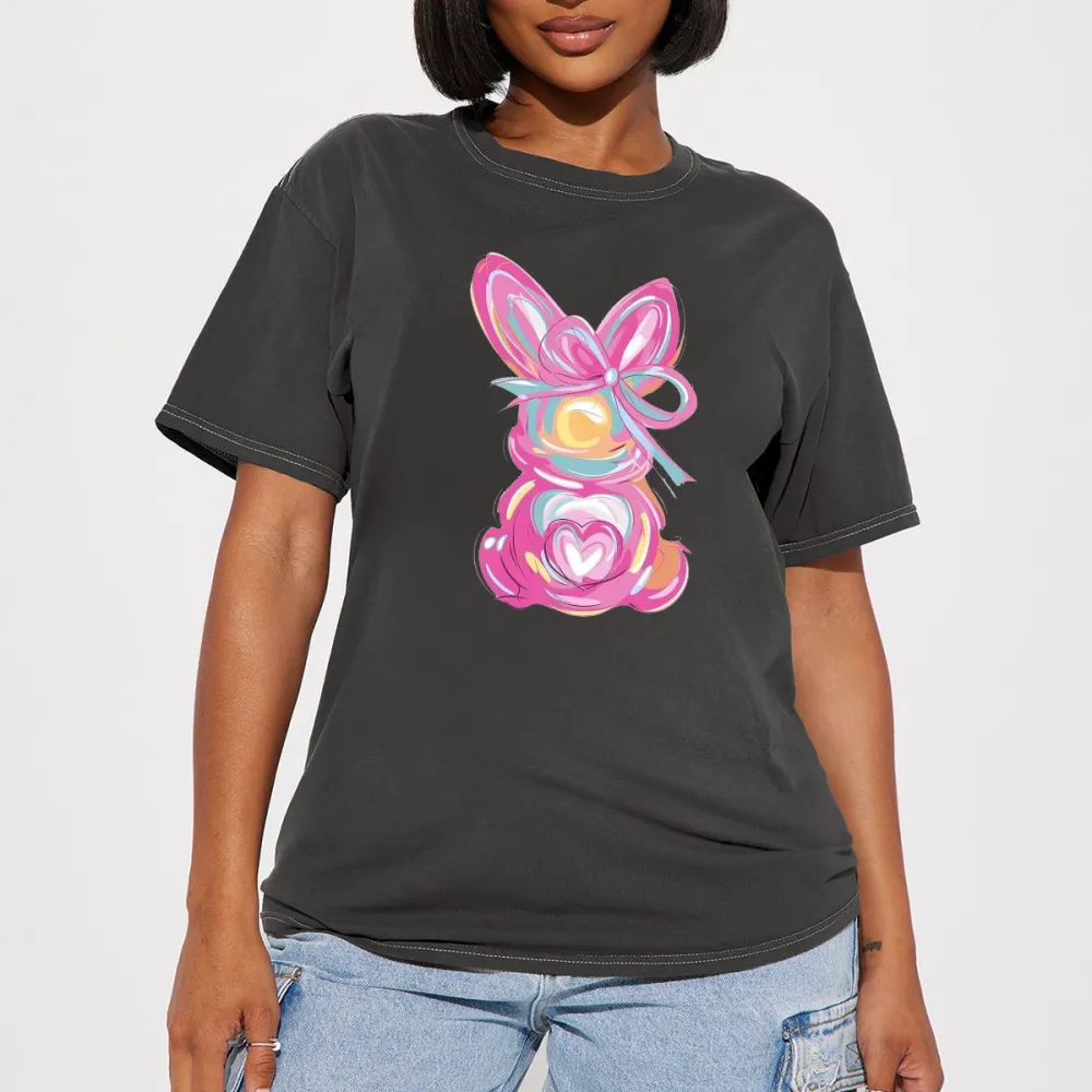 A Hand-Painted Rabbit Pattern With Pink As The Main Color, Matched With Blue, Yellow, Orange And Other Colors. The Rabbit Has Bow And Heart Elements On Its Body. It Is A Casual T-Shirt.