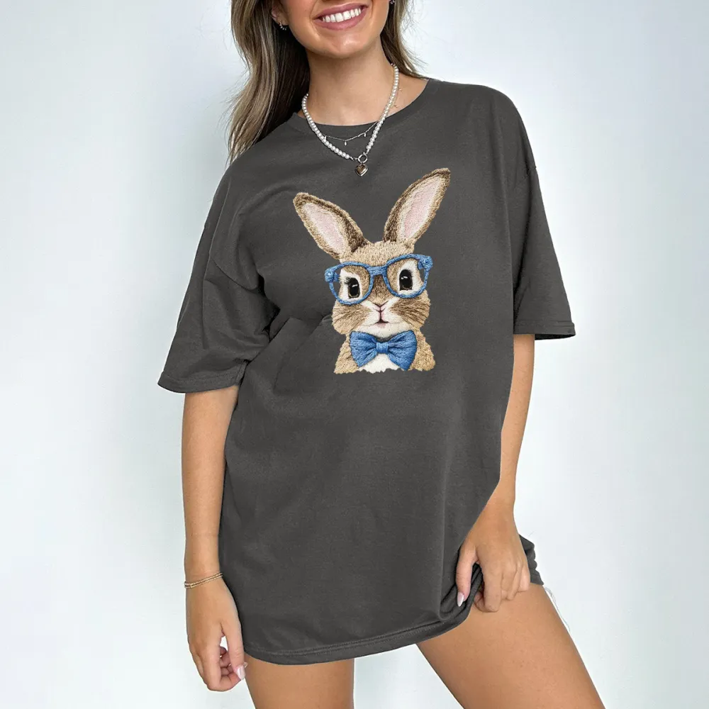 A Rabbit Pattern Wearing Blue Glasses And A Blue Bow Tie Looks Cute And Stylish On A Casual T-Shirt.